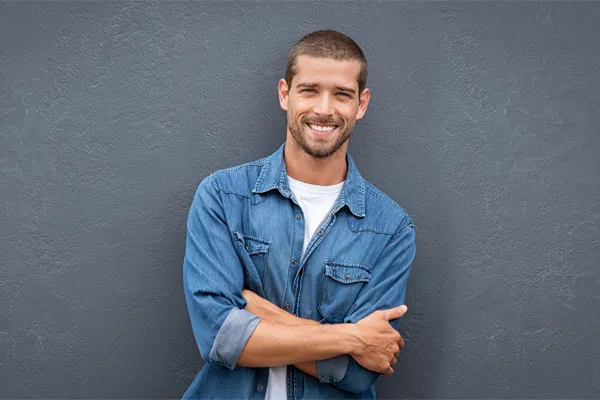 A man with his arms crossed posing for the camera.