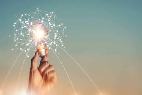 A person holding an electric light in their hand.