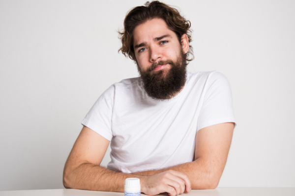A man with long hair and beard sitting at the table
